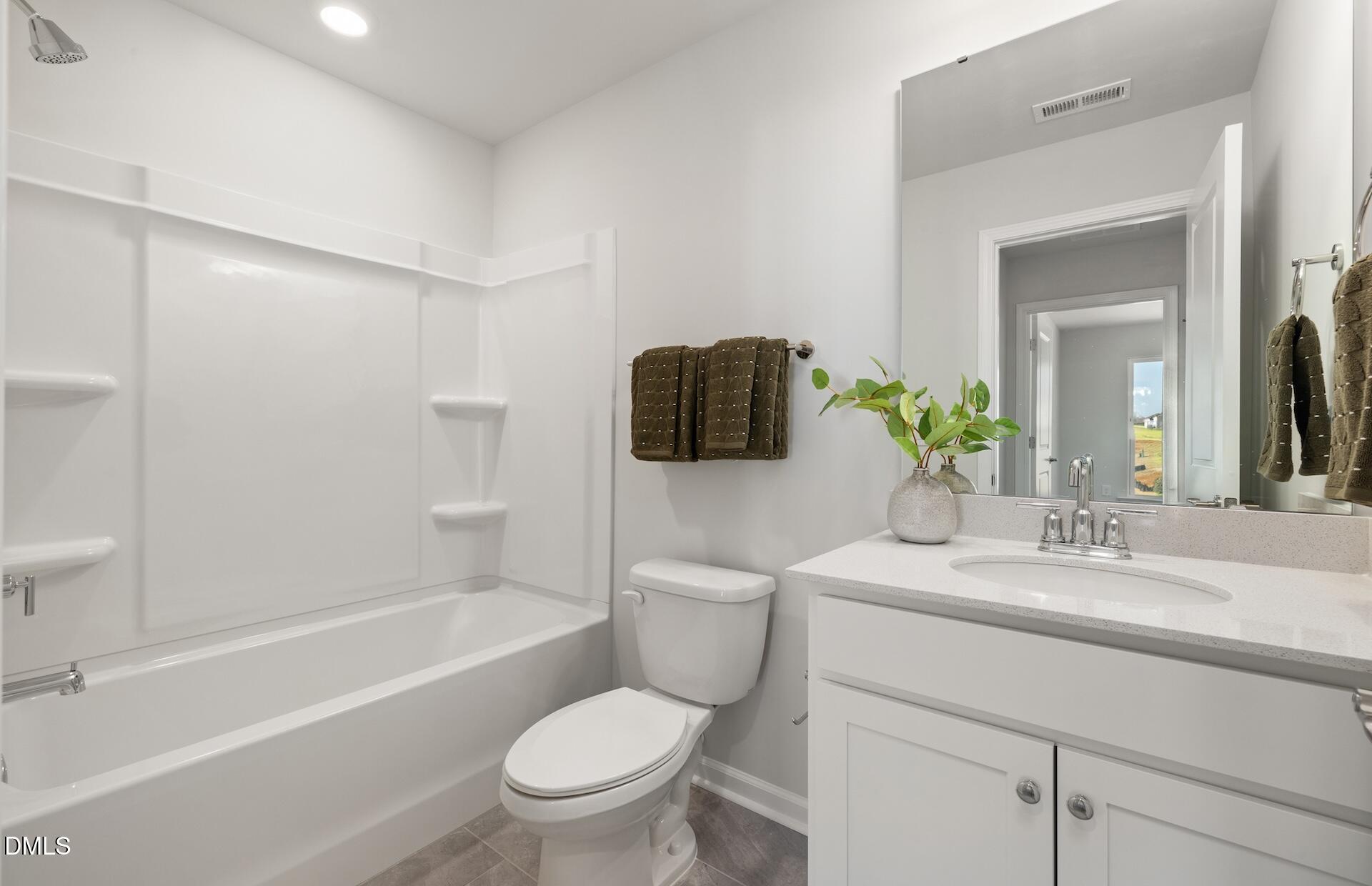 2810 Rodeo Court Fuquay-Varina, NC 27526 - Photo 20 of 30 a bathroom with a sink toilet and shower