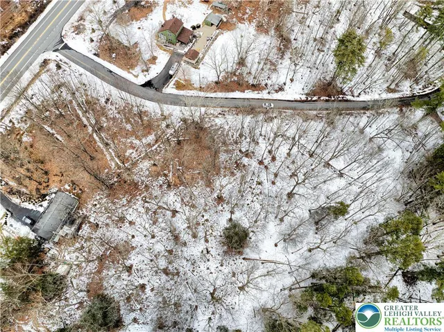 a view of water covered with snow in the background
