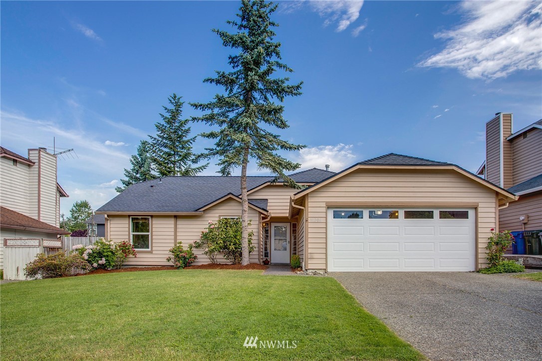 11206 Southeast 268th Street Kent, WA 98030 - Photo 1 of 23 a front view of a house with a garden