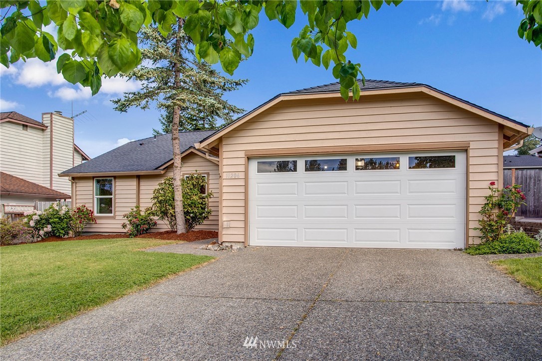 11206 Southeast 268th Street Kent, WA 98030 - Photo 2 of 23 a front view of a house with a yard