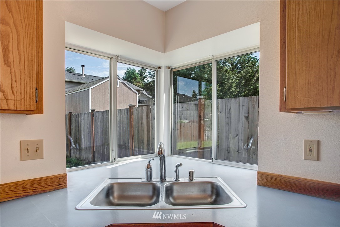 11206 Southeast 268th Street Kent, WA 98030 - Photo 13 of 23 a kitchen with a sink and a large window