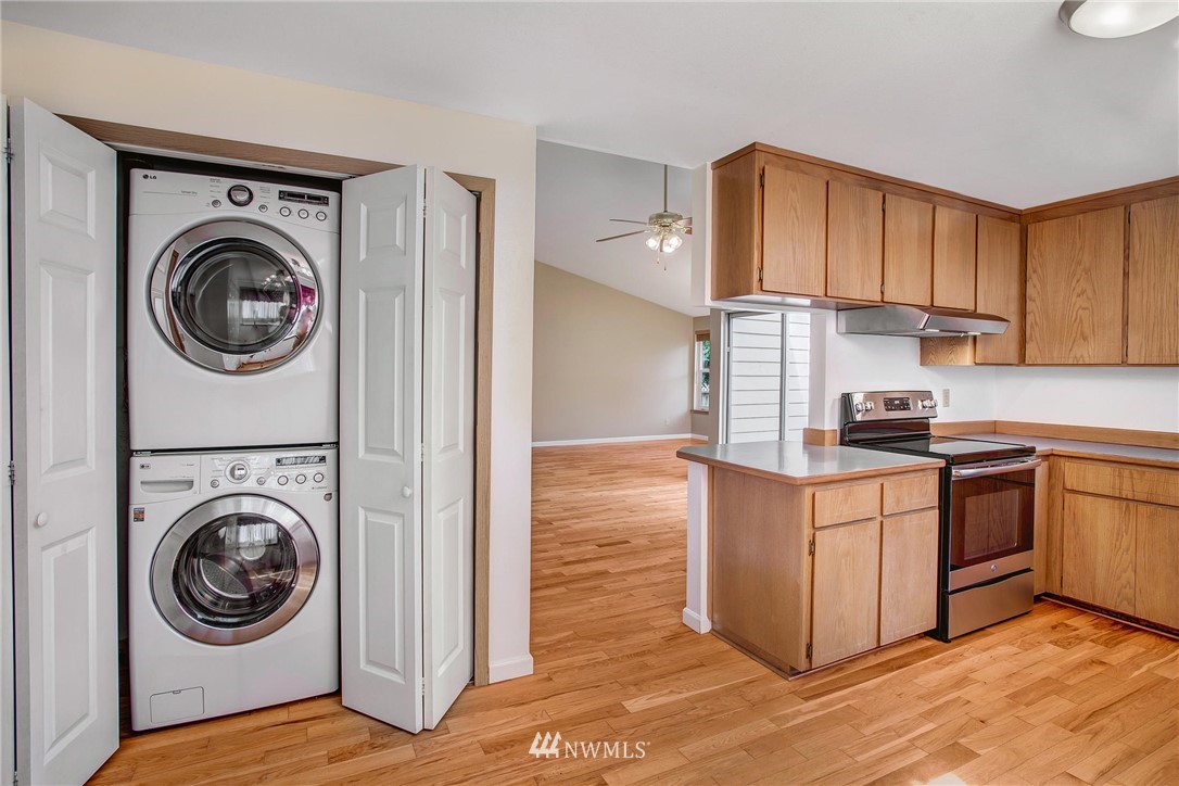 11206 Southeast 268th Street Kent, WA 98030 - Photo 15 of 23 a kitchen with a washer and dryer in it