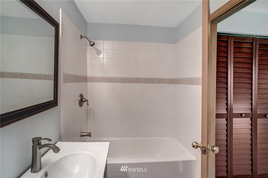 11206 Southeast 268th Street Kent, WA 98030 - Photo 19 of 23 a bathroom with a tub and a sink