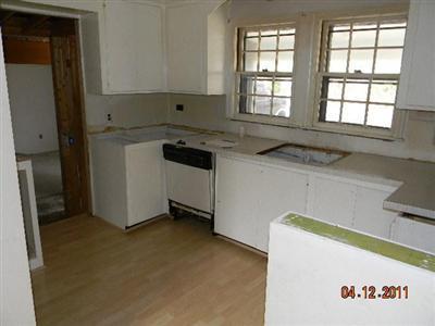 78 Lewis Road Hyannis, MA 02601 - Photo 3 of 13 a kitchen with a sink a stove and a refrigerator
