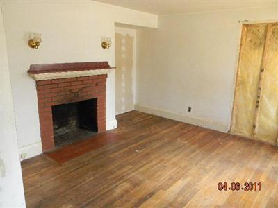 78 Lewis Road Hyannis, MA 02601 - Photo 10 of 13 a view of an empty room with wooden floor and a fireplace