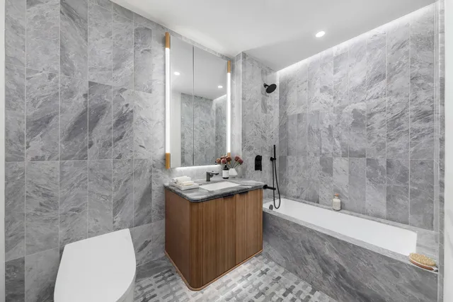 a kitchen with stainless steel appliances a sink and a refrigerator
