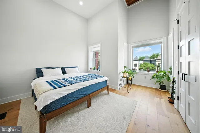 a bedroom with a bed and a potted plant