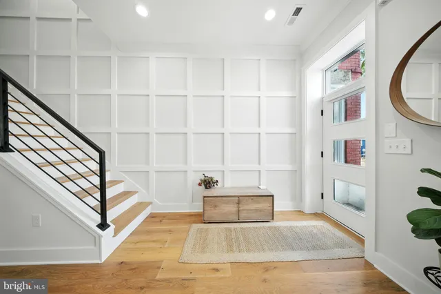 a view of staircase with white walls and a window