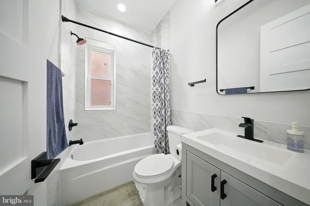 a bathroom with a sink a toilet and a bathtub