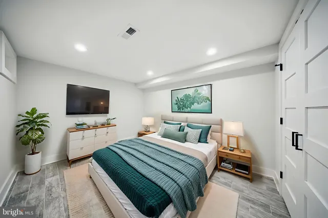 a bedroom with a bed and a flat screen tv