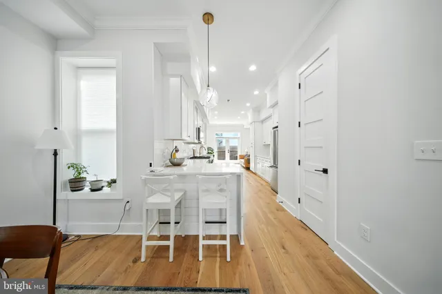 a large white kitchen with a large window