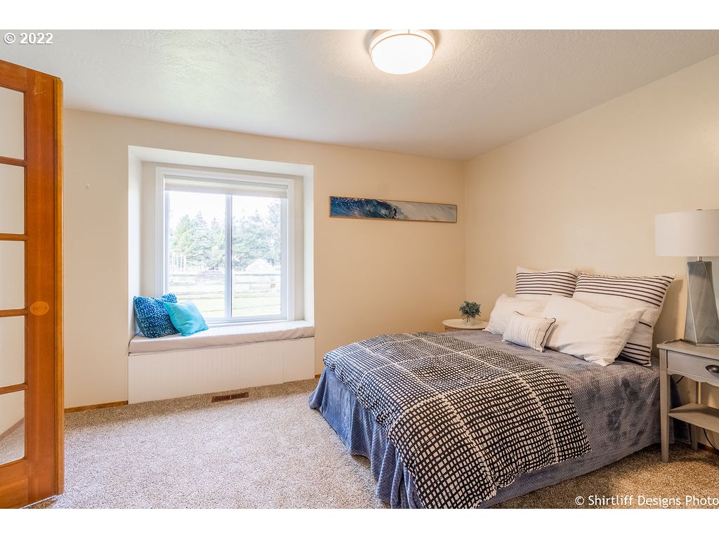 78566 Cedar Park Road Cottage Grove, OR 97424 - Photo 17 of 32 a bedroom with a bed and wooden floor