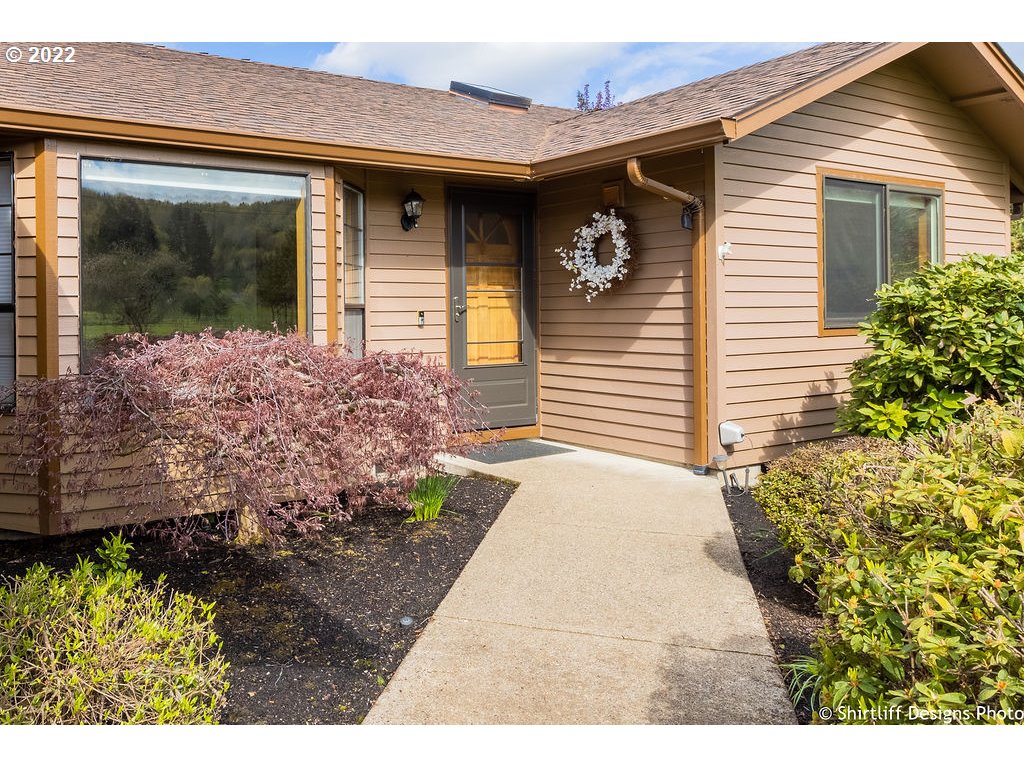78566 Cedar Park Road Cottage Grove, OR 97424 - Photo 3 of 32 a front view of a house with garden