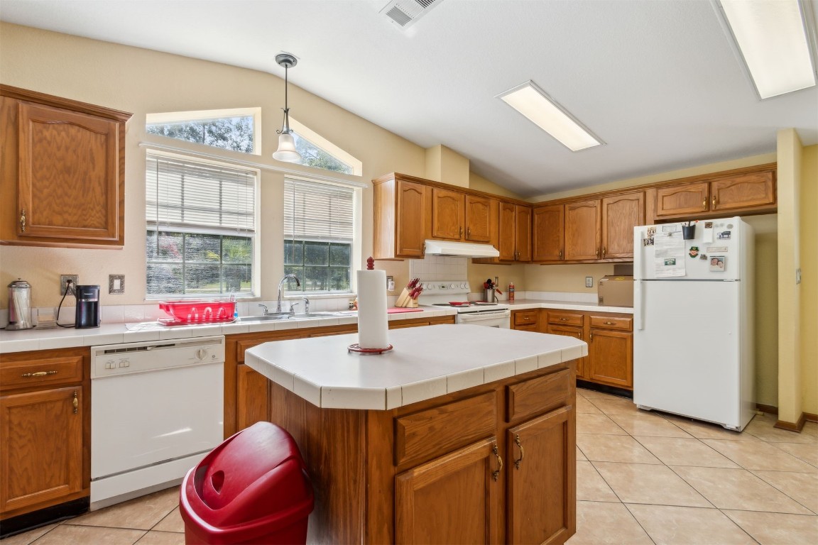 85135 Miner Road Yulee, FL 32097 - Photo 14 of 32 a kitchen with a sink refrigerator and cabinets