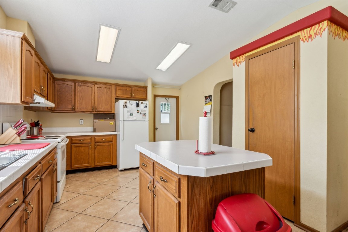 85135 Miner Road Yulee, FL 32097 - Photo 15 of 32 a kitchen with kitchen island a sink appliances and cabinets