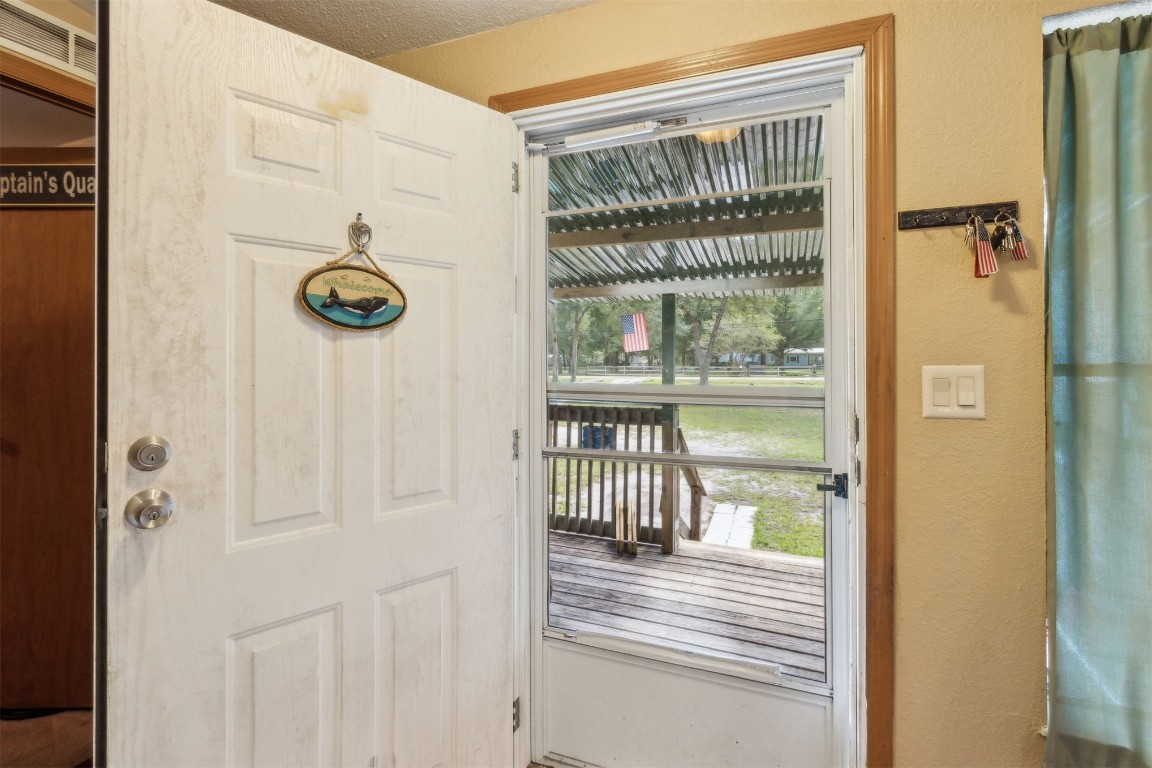 85135 Miner Road Yulee, FL 32097 - Photo 2 of 32 a view of a hallway with wooden floor and door