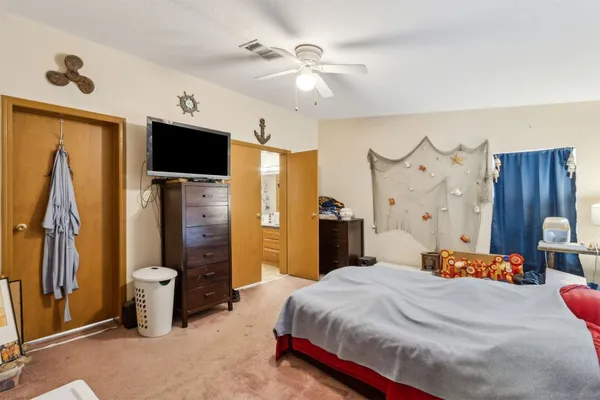 a bedroom with a bed and a chandelier