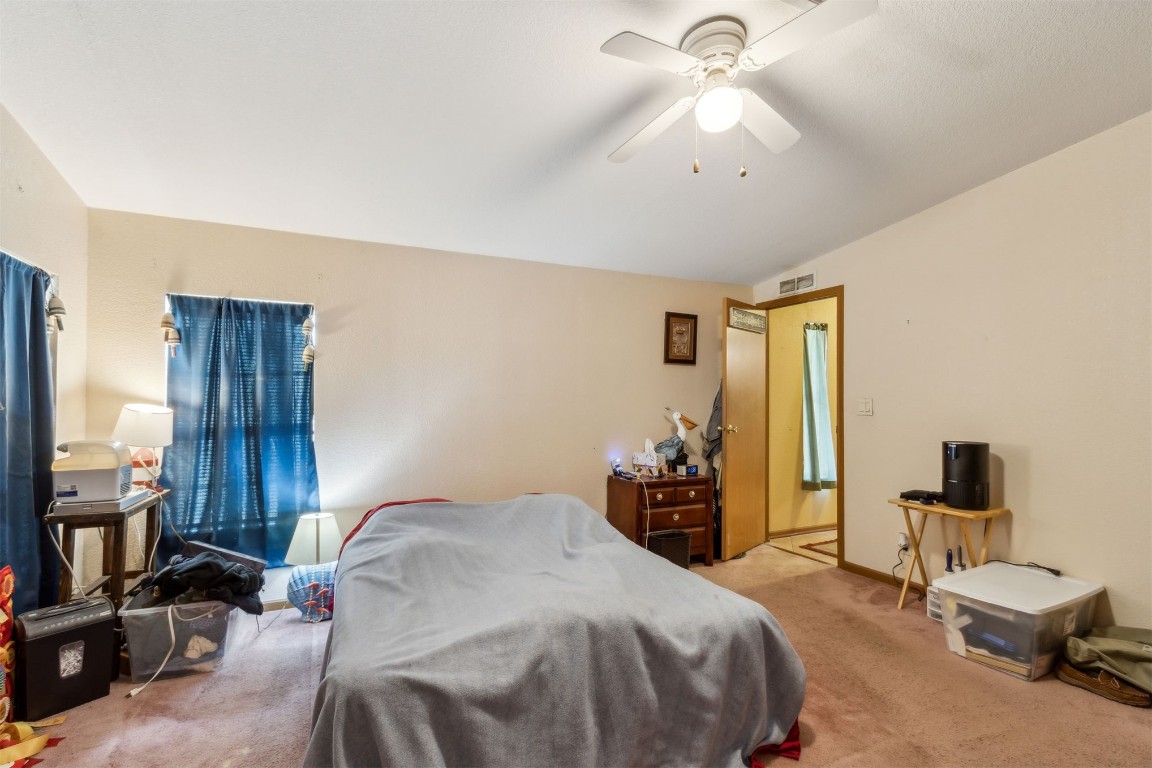 85135 Miner Road Yulee, FL 32097 - Photo 22 of 32 a bedroom with a bed and a chandelier