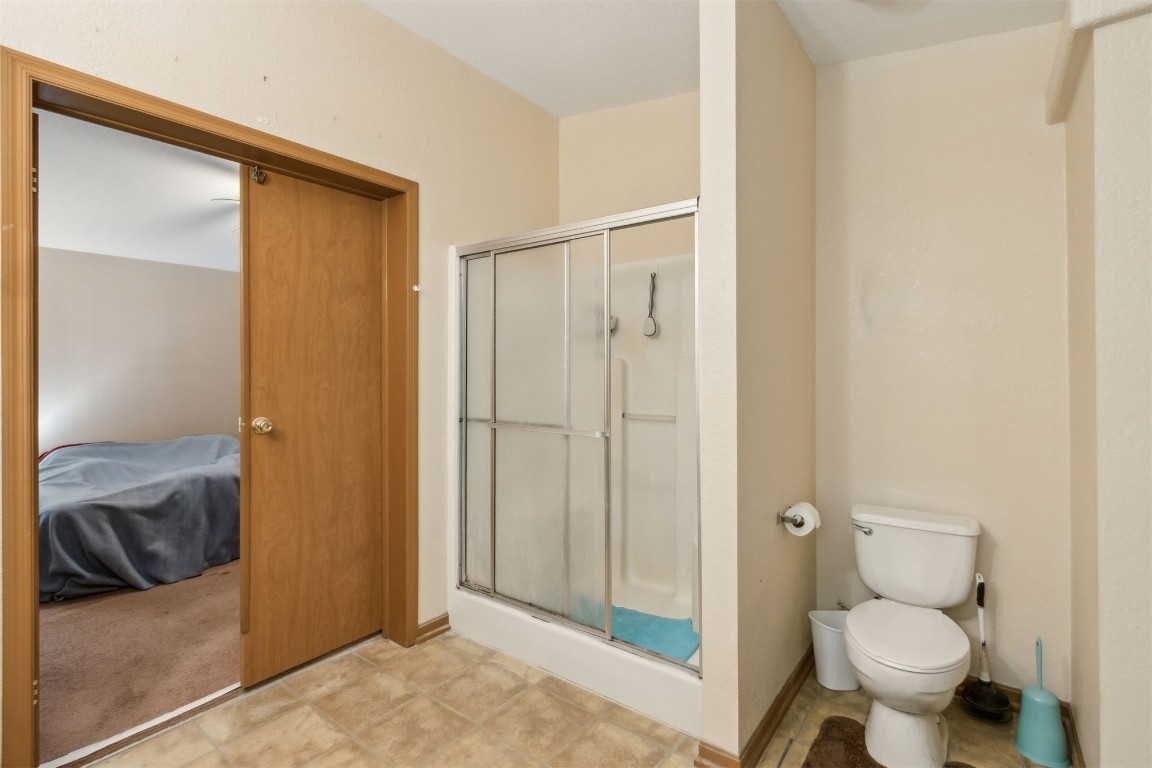 85135 Miner Road Yulee, FL 32097 - Photo 24 of 32 a bathroom with a granite countertop toilet and a shower