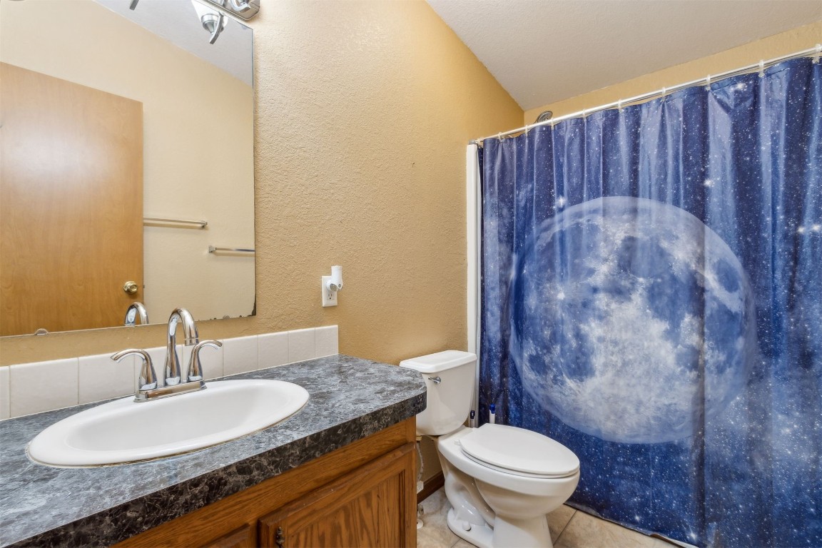 85135 Miner Road Yulee, FL 32097 - Photo 27 of 32 a bathroom with a granite countertop toilet sink and mirror