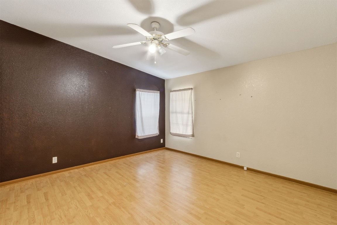 85135 Miner Road Yulee, FL 32097 - Photo 28 of 32 an empty room with a chandelier fan and windows