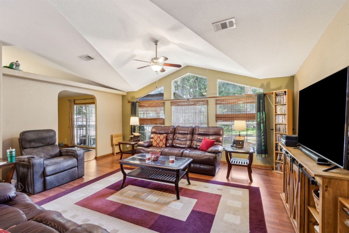 85135 Miner Road Yulee, FL 32097 - Photo 6 of 32 a living room with furniture a flat screen tv and a large window