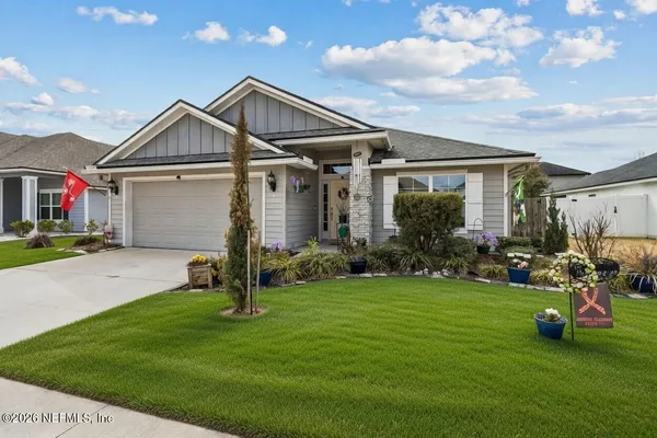a front view of house with yard and green space