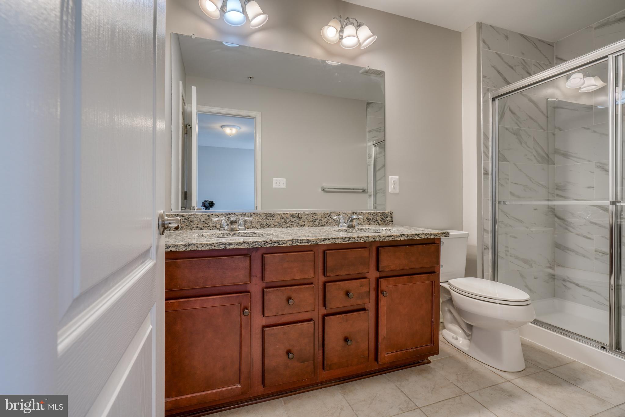 985 Morgan Run Road Middle River, MD 21220 - Photo 26 of 33 a bathroom with a granite countertop sink toilet and shower