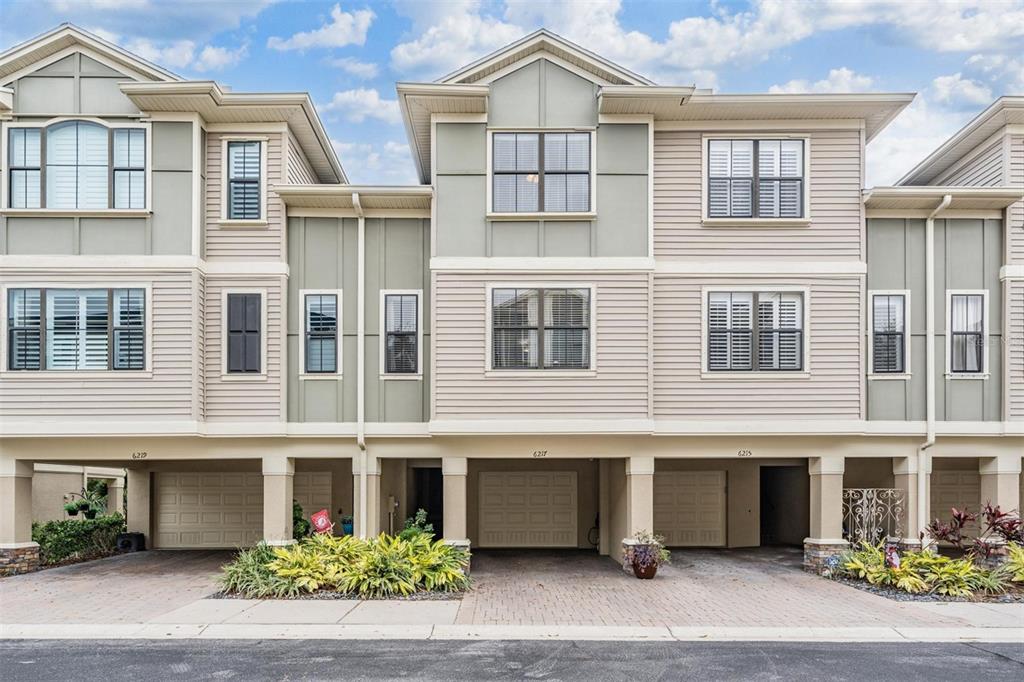 6217 Anhinga Place Tampa, FL 33615 - Photo 1 of 1 a front view of a residential apartment building with a garden