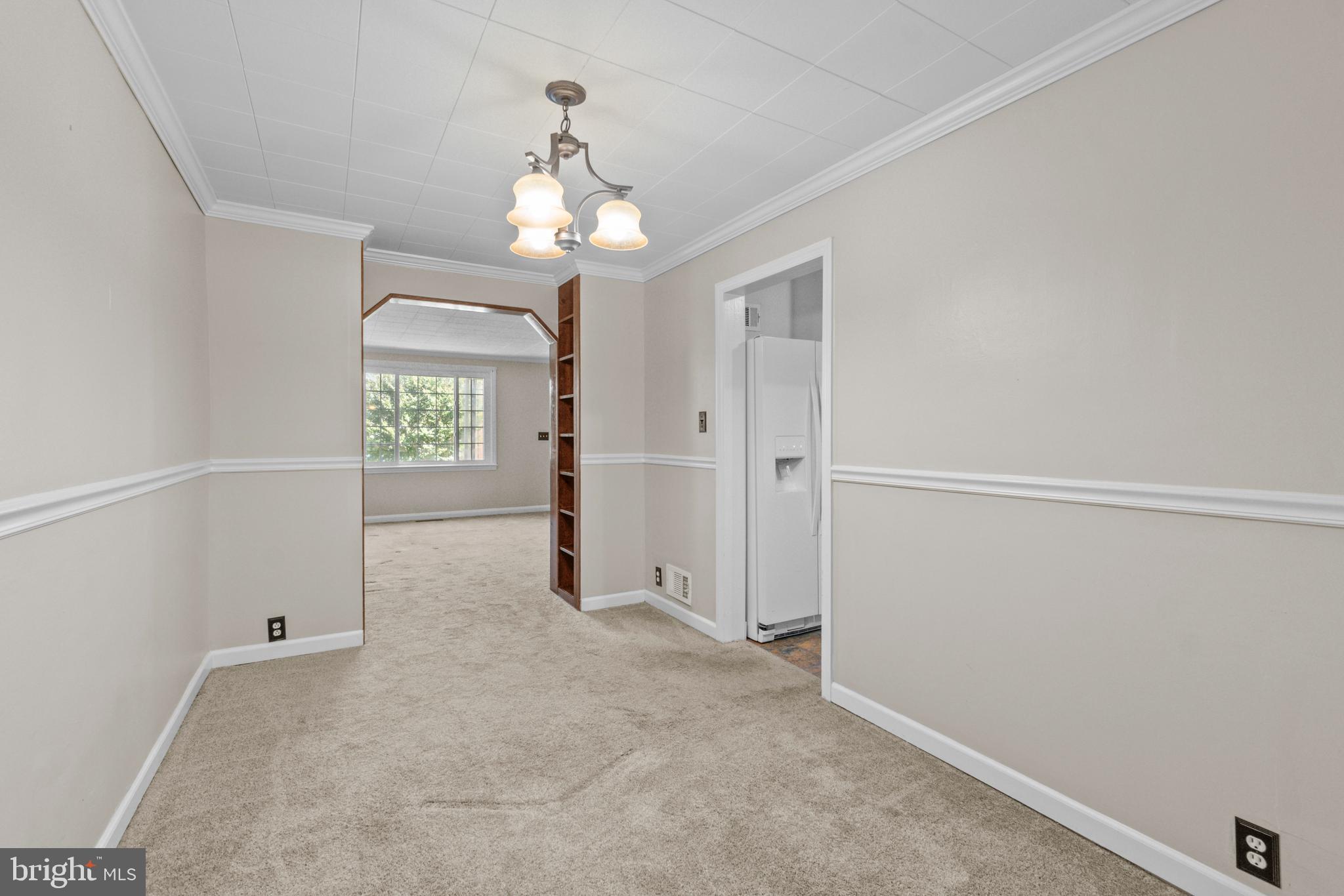 5514 Council Street Halethorpe, MD 21227 - Photo 6 of 36 an empty room with windows and chandelier