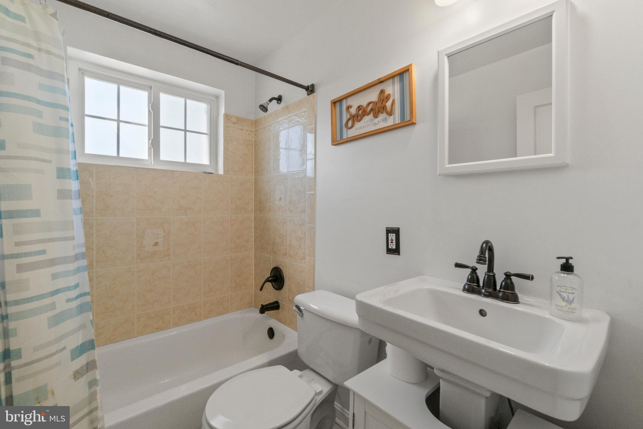 5514 Council Street Halethorpe, MD 21227 - Photo 7 of 36 a bathroom with a sink toilet and bathtub