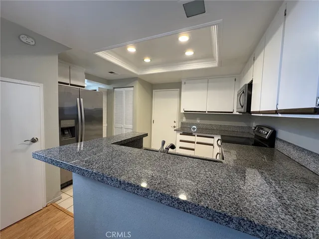 a kitchen with white cabinets