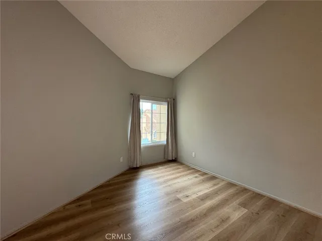 a view of a room with wooden floor and window