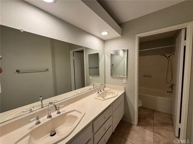 a bathroom with a double vanity sink and mirror