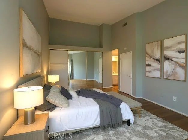 a bedroom with a bed and a lamp on table