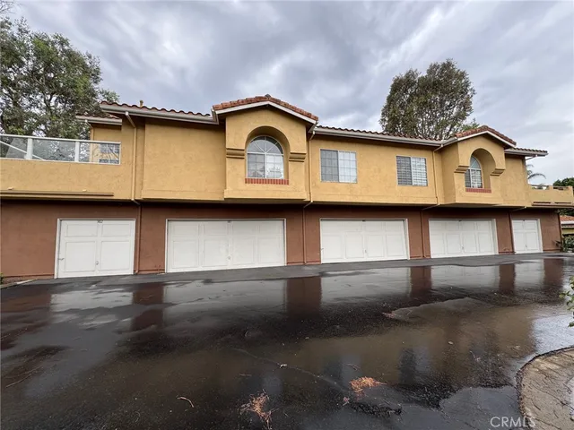 a view of a swimming pool with lawn chairs under an umbrella
