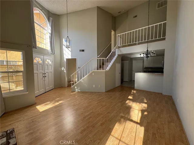 a kitchen with kitchen island granite countertop a stove sink and cabinets