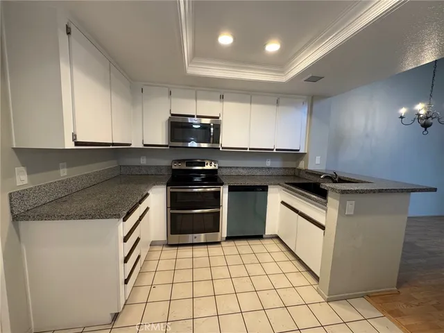 a kitchen with granite countertop a stove and a microwave