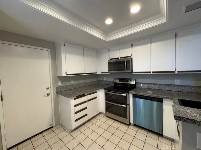 a kitchen with a refrigerator and a sink