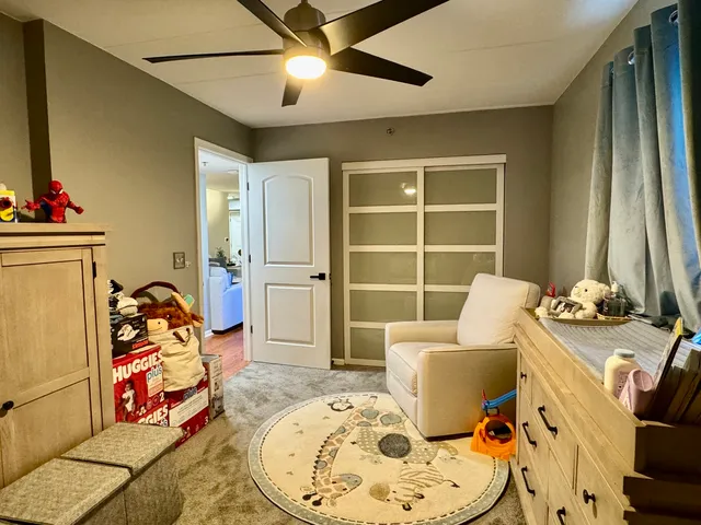 a bedroom with a bed a table and chair