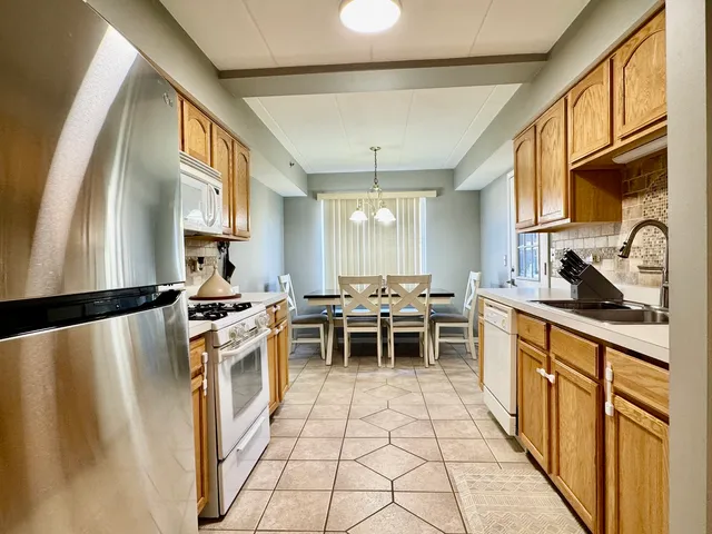 a kitchen with a stove and a wooden cabinets