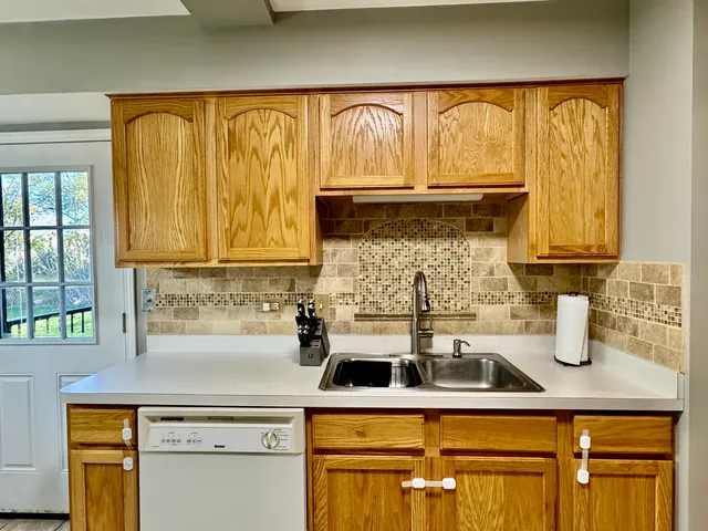 a kitchen with a sink cabinets and wooden floor