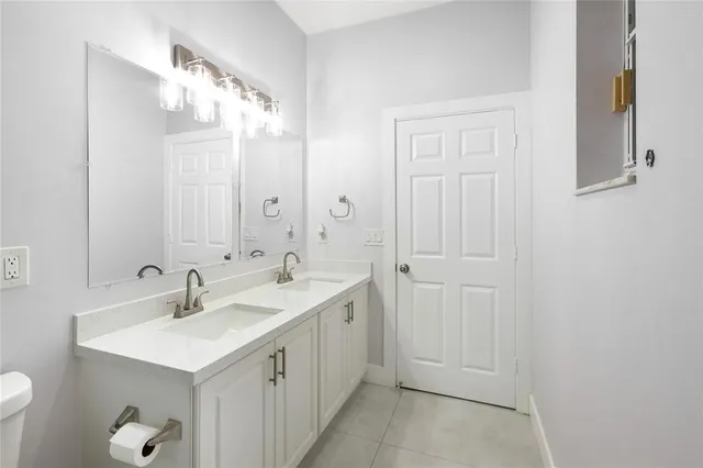a bathroom with 2 sink and a mirror