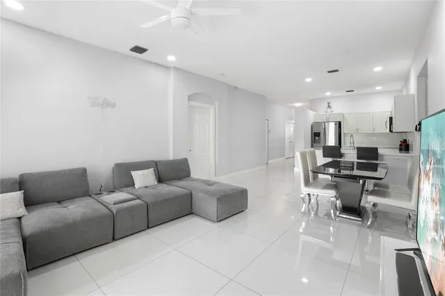 a living room with furniture a table and a projector screen