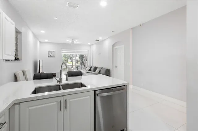 a kitchen with a sink and white cabinets