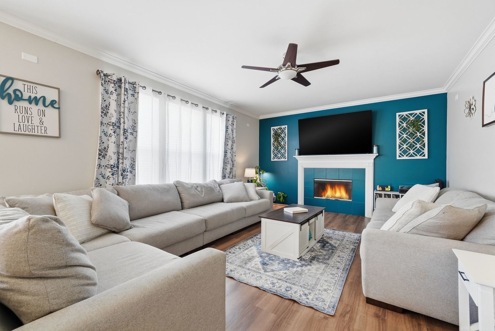 25216 Spring Street Manhattan, IL 60442 - Photo 7 of 28 a living room with furniture a flat screen tv and a fireplace