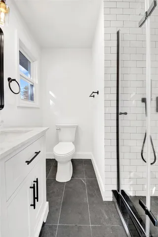 a bathroom with a toilet and a shower