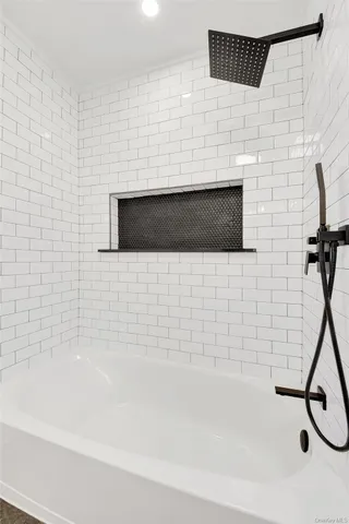 a bathroom with a bathtub and a shower