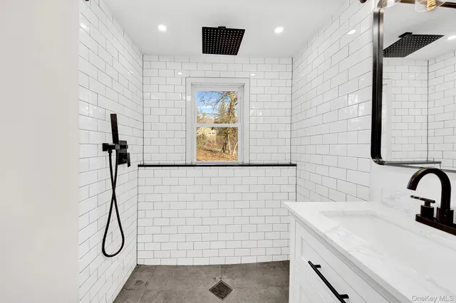 a bathroom with a sink a toilet and mirror