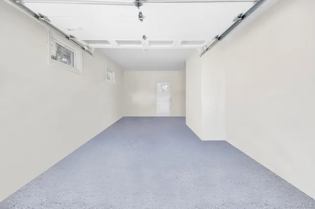 an empty room with a ceiling fan and window
